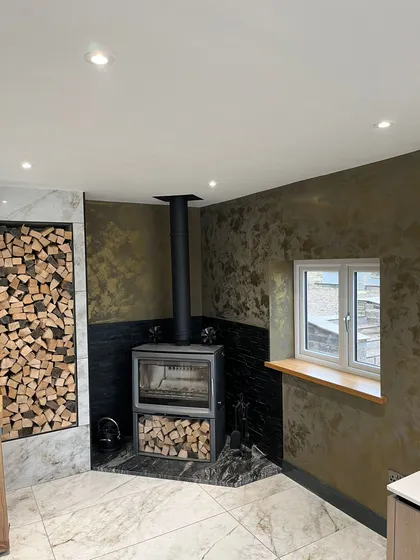 woodburning fireplace in corner of room