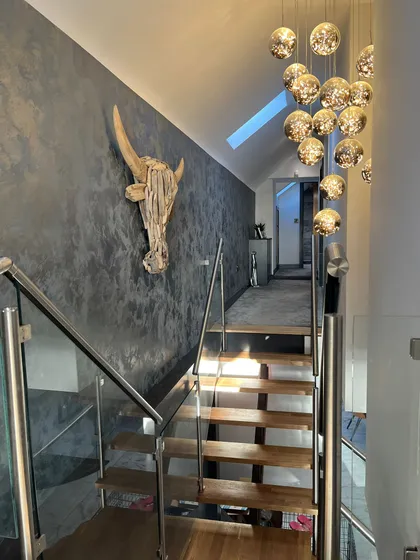 Staircase with a cows head ornament on the wall