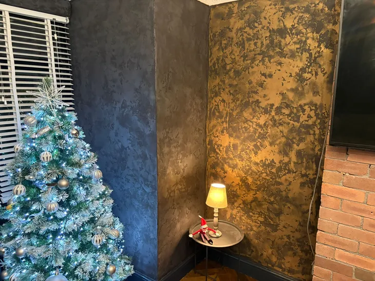 venetian plaster on wall next to a christmas tree